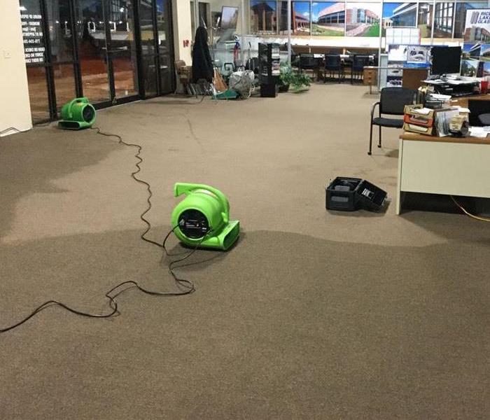 Water damage in Business and SERVPRO equipment set for mitigation